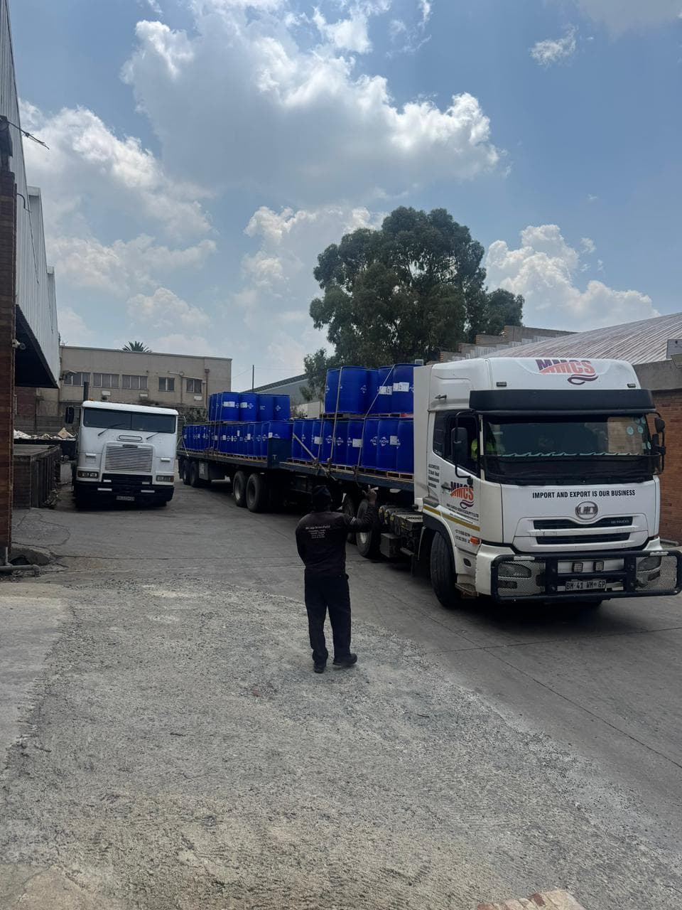 MMCS truck with blue chemical drums on flatbed in the company yard