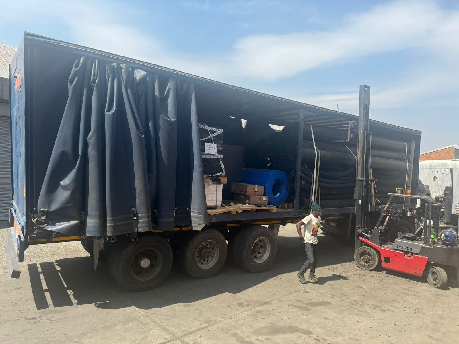 Open MMCS tautliner being loaded by forklift