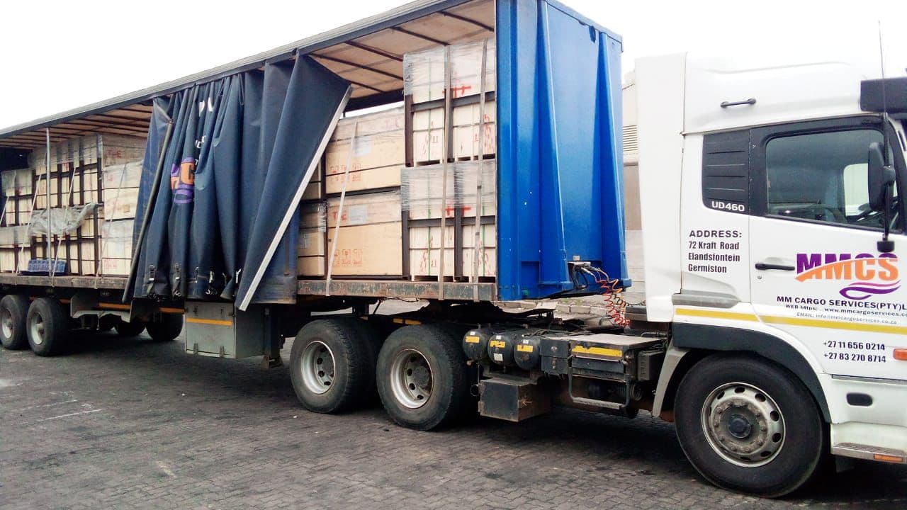 MMCS Freightliner Argosy with branded tautliner under blue sky